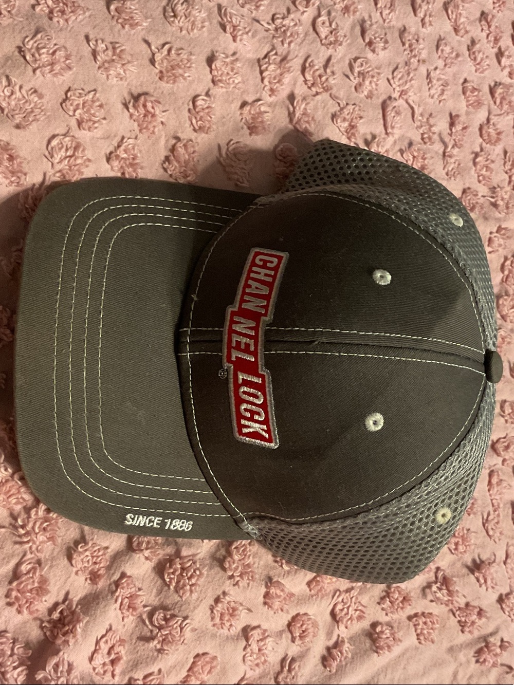 CHANEL Black Mesh Trucker Cap with Red Logo Patch